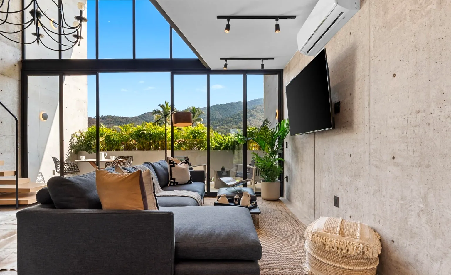Living area with floor-to-ceiling windows to the mountains
