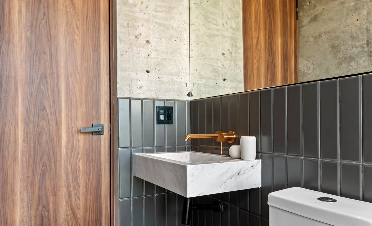 Marble vanity with brushed-gold tap