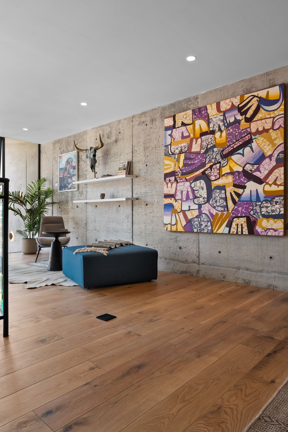 Serene living space bathed in soft afternoon light, with original art