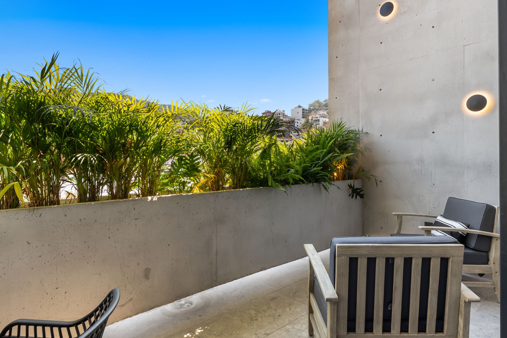 Loungers facing the Puerto Vallarta hills, palms and open sky